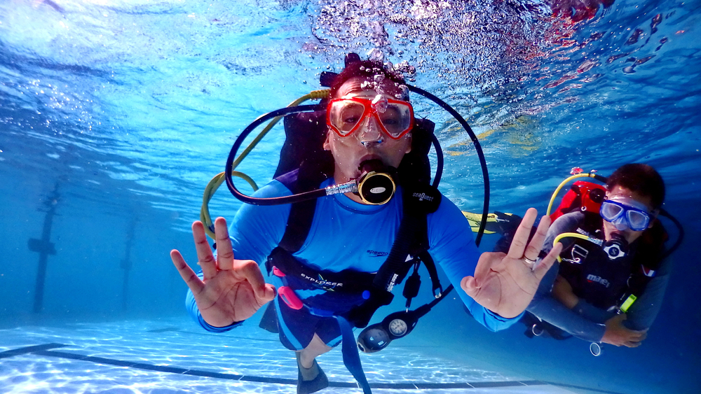 A group of people are practicing diving in a swimming pool in Batang, Indonesia